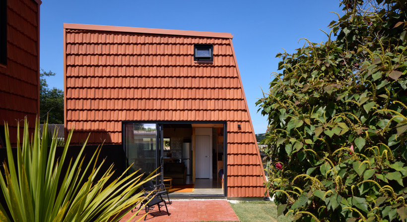 Terracotta Roof Tiles Repurposed as Striking Wall Cladding for Pocket House