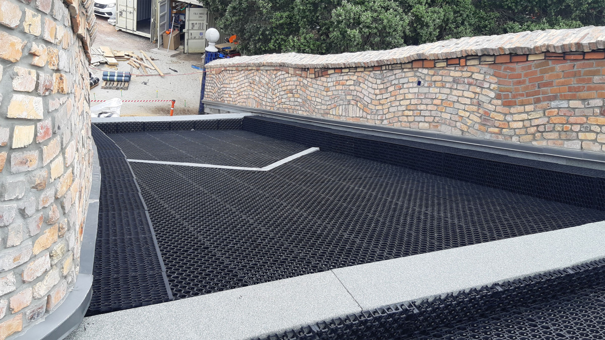 Installation of drainage layers over waterproofing membrane on main roof.