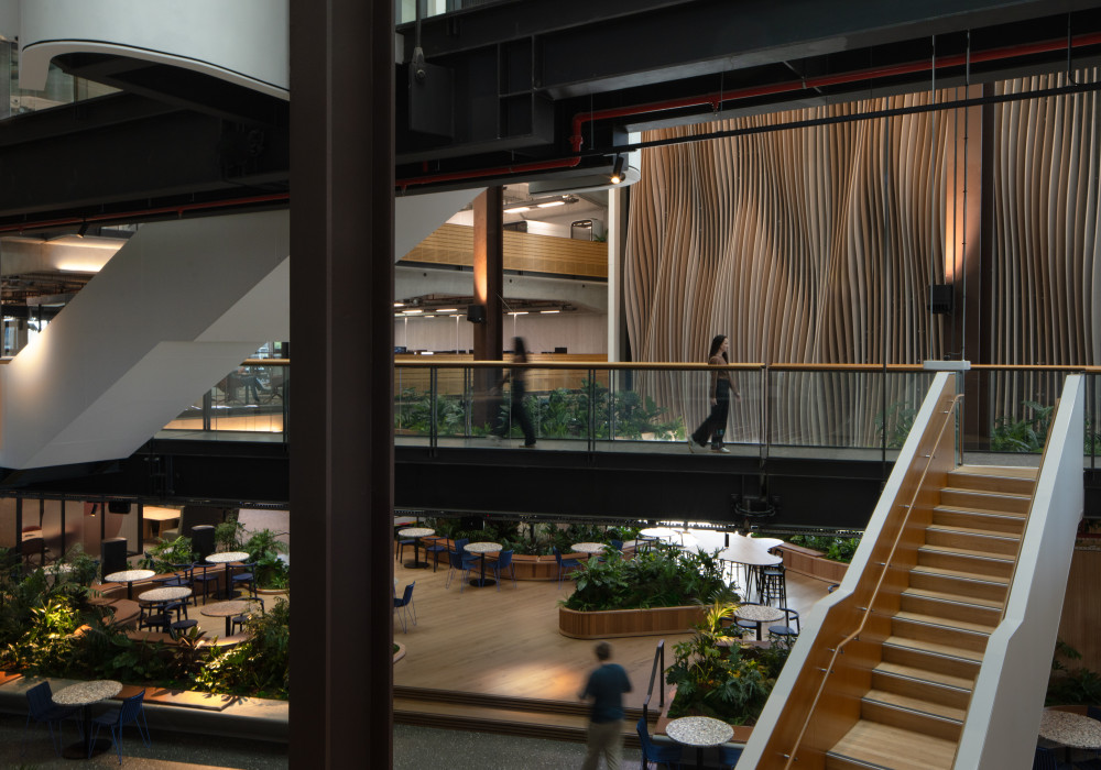 Bespoke Acoustic Feature Wall Reduces Reverberation in a Shared Office Atrium