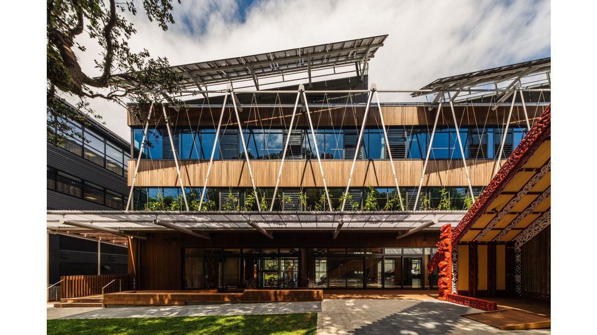 The meeting house, Te Tumu Herenga Waka, sits behind Ngā Mokopuna