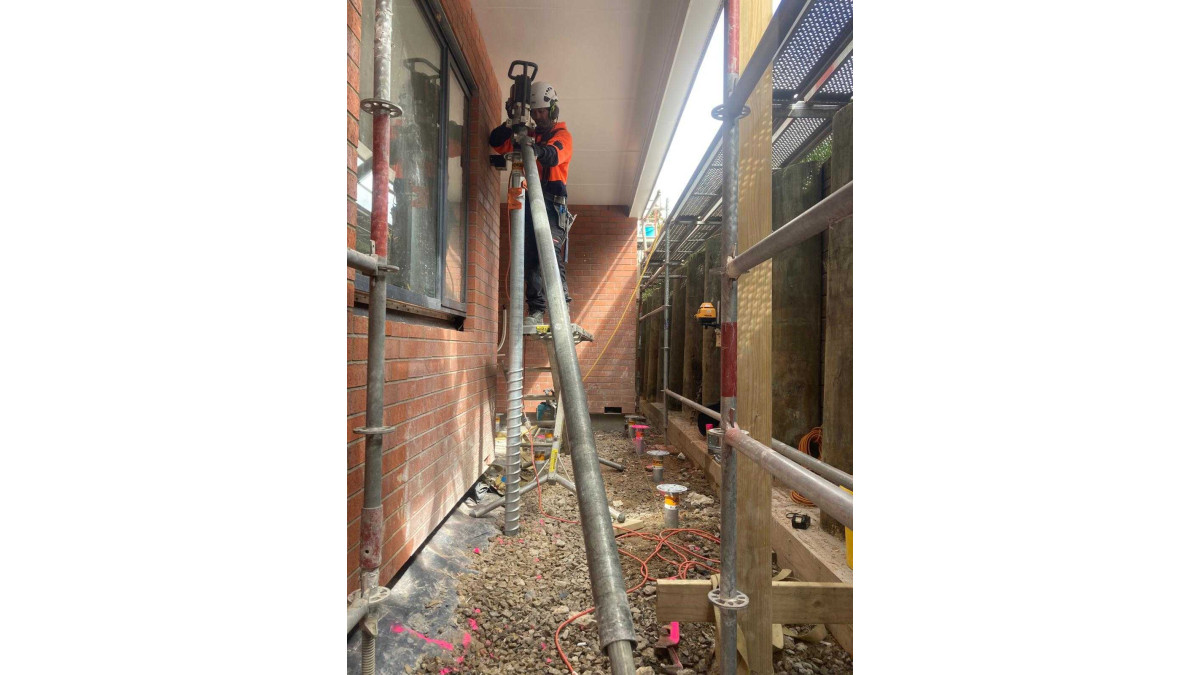On one of the blocks, the StopDigging team had even narrower site access. Here they used electric hand drills to complete the deck foundations.