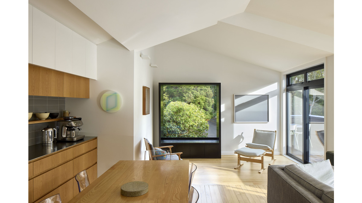 The bay window sits underneath a fixed-pane Vantage Metro Series window.
