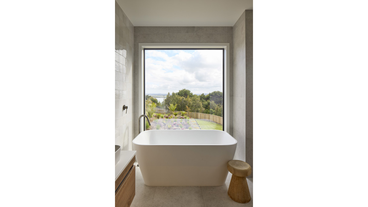 The light-filled bathroom features a large double-glazed picture window.